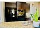 Modern kitchen features stainless steel appliances, granite countertops, and dark wood cabinetry at 5705 Petrified Tree Ln, North Las Vegas, NV 89081