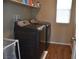 Convenient laundry room features modern washer and dryer set with ample shelving at 5705 Petrified Tree Ln, North Las Vegas, NV 89081