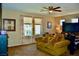 Spacious main bedroom with a cozy seating area, plush carpet, and natural light at 5705 Petrified Tree Ln, North Las Vegas, NV 89081