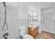 Bathroom with tiled shower, toilet, wooden vanity with sink and mirrored cabinet and tiled walls at 5871 Mescal Way, Las Vegas, NV 89110