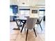 Cozy kitchen nook with a round table and modern gray chairs near the kitchen and bright windows at 6205 Windy Oaks Ct, Las Vegas, NV 89139