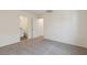 Bedroom featuring neutral carpet, white walls, and access to the bathroom at 6731 Violet Cascade Ave, Las Vegas, NV 89156