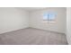 Bedroom features plush carpet, a bright window, and crisp white walls at 6737 Violet Cascade Ave, Las Vegas, NV 89156