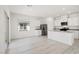 Open-concept kitchen features white cabinetry, stainless steel appliances, and abundant natural light at 6737 Violet Cascade Ave, Las Vegas, NV 89156