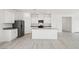 Bright kitchen features white cabinetry, a center island, stainless steel appliances, and recessed lighting at 6737 Violet Cascade Ave, Las Vegas, NV 89156
