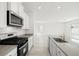 Well-equipped kitchen with gray counters, gas range, modern appliances, and tile floors at 6737 Violet Cascade Ave, Las Vegas, NV 89156