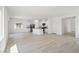 Bright open-concept living room with modern floors connecting to a kitchen, showcasing a seamless design at 6737 Violet Cascade Ave, Las Vegas, NV 89156