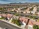 An aerial view showing a desert community with well-maintained landscaping and stunning mountain views at 7021 Feather Pine St, Las Vegas, NV 89131