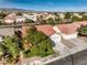 Aerial view of a residential area with well-maintained homes, mature trees, and lush green lawns at 7021 Feather Pine St, Las Vegas, NV 89131