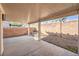 Back patio area with cover, brick walls, and rock landscaping at 7021 Feather Pine St, Las Vegas, NV 89131