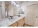Bathroom featuring double sinks, modern fixtures, and a large mirror at 7021 Feather Pine St, Las Vegas, NV 89131
