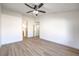 Spacious bedroom featuring modern light fixture and access to bathroom at 7021 Feather Pine St, Las Vegas, NV 89131