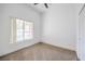 Bright bedroom with carpet, closet, ceiling fan, and a large window providing ample natural light at 7021 Feather Pine St, Las Vegas, NV 89131