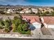 Aerial view of home showing the driveway, garage, and landscaping, with desert mountains in the distance at 7021 Feather Pine St, Las Vegas, NV 89131