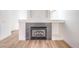Close up of fireplace featuring gray tile surround and white mantle with built-in display shelves at 7021 Feather Pine St, Las Vegas, NV 89131