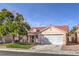 Single-story home featuring a 2-car garage, tile roof, mature tree, well-maintained lawn, and desert landscaping at 7021 Feather Pine St, Las Vegas, NV 89131