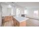 Spacious kitchen with island, light wood cabinets, and sleek stainless steel appliances at 7021 Feather Pine St, Las Vegas, NV 89131