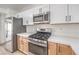 Modern kitchen features stainless steel appliances, white countertops, and light wood cabinetry at 7021 Feather Pine St, Las Vegas, NV 89131