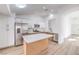 Bright kitchen boasts stainless appliances, island, and seamless transition to adjacent rooms at 7021 Feather Pine St, Las Vegas, NV 89131