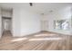 Bright living room with wood-look flooring, a ceiling fan, recessed lighting, and neutral-colored walls at 7021 Feather Pine St, Las Vegas, NV 89131