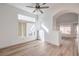 Bright living room featuring modern flooring, a ceiling fan, recessed lighting, an arched entryway, and bright windows at 7021 Feather Pine St, Las Vegas, NV 89131