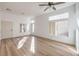 Bright living room with wood-look flooring, a ceiling fan, recessed lighting, and clerestory windows at 7021 Feather Pine St, Las Vegas, NV 89131