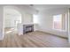 Bright living room featuring a fireplace, light wood floors and an open floorplan at 7021 Feather Pine St, Las Vegas, NV 89131