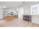 Open floorplan featuring a living room with fireplace and a kitchen with stainless appliances at 7021 Feather Pine St, Las Vegas, NV 89131
