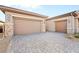 Long brick driveway leading to a two-car garage with desert landscaping at 7417 Deschutes Cir, Las Vegas, NV 89129