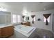 Bathroom featuring double sink vanity, large soaking tub, and tiled flooring at 764 Canary Wharf Dr, Las Vegas, NV 89178