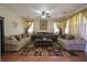 Spacious living room features a ceiling fan and large windows with decorative curtains at 764 Canary Wharf Dr, Las Vegas, NV 89178