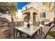 Cozy backyard patio with modern table set, hardscape sitting area and outdoor grill at 7681 Black River St, Las Vegas, NV 89139