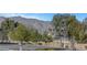 Street view features lush trees in front of houses with mountain views at 7771 Pleasant Slopes Ct, Las Vegas, NV 89131