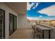 Balcony with exterior views, table, and two chairs overlooking a road with houses in the distance at 800 Loch Katrine Ave, Henderson, NV 89012