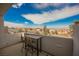 Balcony view with patio furniture overlooking houses and blue skies with scattered clouds at 800 Loch Katrine Ave, Henderson, NV 89012