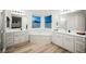 Bright bathroom featuring dual sinks, a large soaking tub, and a separate shower at 800 Loch Katrine Ave, Henderson, NV 89012