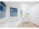 Bright bathroom features a soaking tub and white cabinets, with a focus on comfort and relaxation at 800 Loch Katrine Ave, Henderson, NV 89012