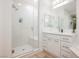 Clean and modern bathroom featuring a glass-enclosed shower and white vanity with ample storage at 800 Loch Katrine Ave, Henderson, NV 89012