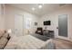 Well-lit bedroom with a light wood floor, queen bed, and a door to the ensuite bathroom at 800 Loch Katrine Ave, Henderson, NV 89012