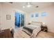 A stylish bedroom with desk and walkout features light-colored walls and wood-look floors at 800 Loch Katrine Ave, Henderson, NV 89012