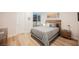 Well-lit bedroom with stylish furnishings, a bed with a wooden headboard, and neutral colors at 800 Loch Katrine Ave, Henderson, NV 89012