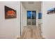 Bright hallway features light wood floors, and access to a balcony offering a seamless blend of indoor and outdoor living at 800 Loch Katrine Ave, Henderson, NV 89012