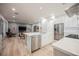 Bright, open kitchen with white cabinetry, stainless steel appliances, and seamless flow to living area at 800 Loch Katrine Ave, Henderson, NV 89012
