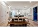 Open floorplan kitchen and dining area featuring an island, modern cabinetry, and stainless steel appliances at 800 Loch Katrine Ave, Henderson, NV 89012