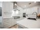 Spacious kitchen boasts white cabinetry, stainless steel appliances, and a large island with a sink at 800 Loch Katrine Ave, Henderson, NV 89012