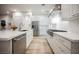 Open-concept kitchen with a stainless-steel appliances, white countertops, and hardwood floors at 800 Loch Katrine Ave, Henderson, NV 89012