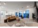 Expansive living room with an open layout, plush seating, and a view of the modern kitchen at 800 Loch Katrine Ave, Henderson, NV 89012