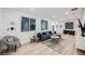 Comfortable living room featuring gray sectional couch, hardwood floors, modern furnishings, and ambient lighting at 800 Loch Katrine Ave, Henderson, NV 89012