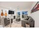Upstairs living room features hardwood floors, modern furniture, and a wet bar at 800 Loch Katrine Ave, Henderson, NV 89012