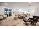 Open living area with contemporary furnishings, hardwood floors, and access to the patio at 800 Loch Katrine Ave, Henderson, NV 89012